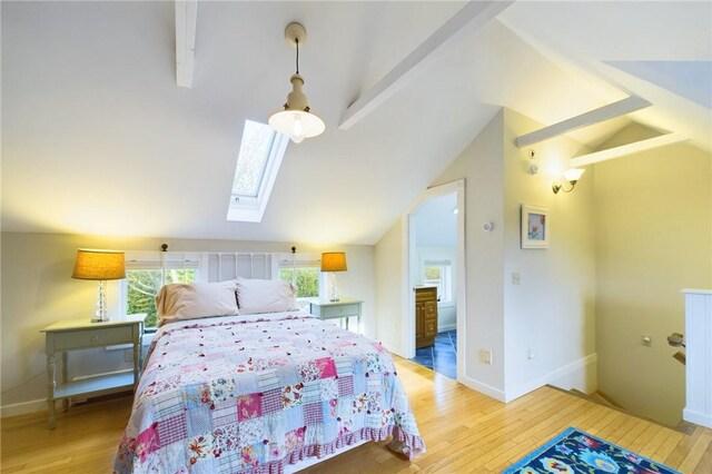 1087 Lakeside Dr, Block Island, RI 02807 - bedroom with vaulted ceiling, light wood-style flooring, a skylight, and baseboards