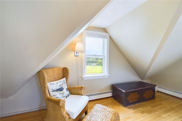 1087 Lakeside Dr, Block Island, RI 02807 - sitting room with baseboard heating, lofted ceiling, and wood finished floors