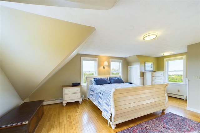 1087 Lakeside Dr, Block Island, RI 02807 - bedroom featuring a baseboard radiator, light wood-style flooring, and lofted ceiling
