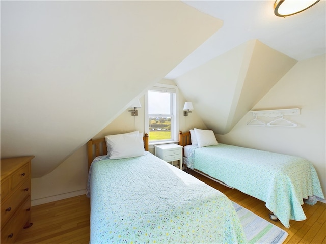 1087 Lakeside Dr, Block Island, RI 02807 - bedroom with hardwood / wood-style floors and vaulted ceiling