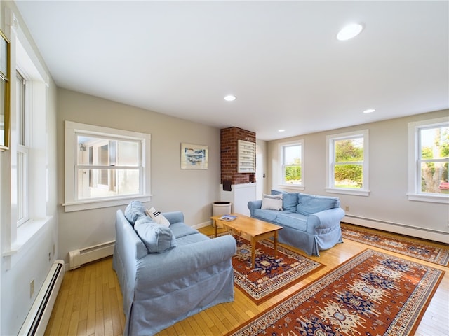 1087 Lakeside Dr, Block Island, RI 02807 - living room with baseboard heating, light wood finished floors, a baseboard radiator, recessed lighting, and baseboards
