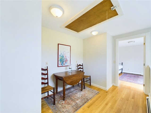 1087 Lakeside Dr, Block Island, RI 02807 - office area with attic access, a baseboard radiator, and light wood-style floors