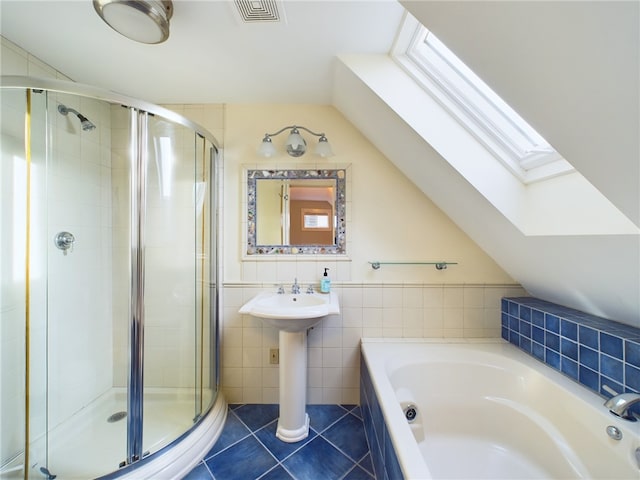 1087 Lakeside Dr, Block Island, RI 02807 - bathroom featuring a skylight, a bath, a shower stall, tile patterned floors, and vaulted ceiling