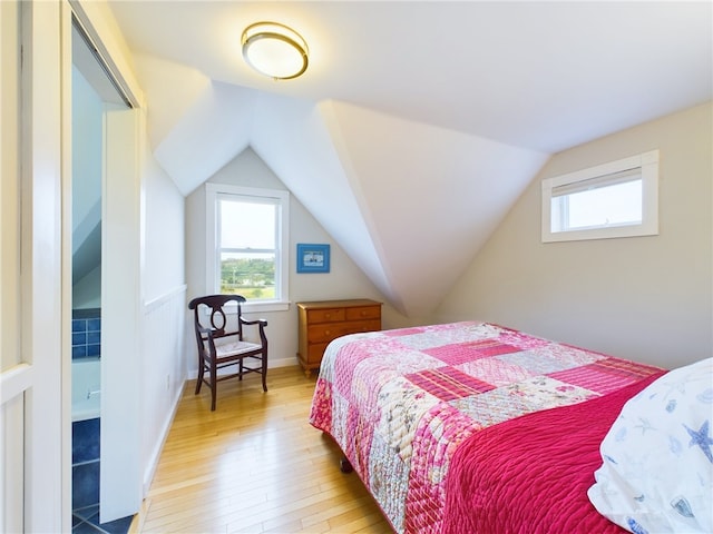 1087 Lakeside Dr, Block Island, RI 02807 - bedroom with light wood-type flooring and vaulted ceiling