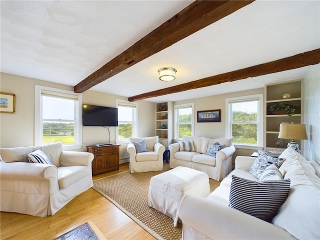 1087 Lakeside Dr, Block Island, RI 02807 - living area with light wood-style floors, a baseboard heating unit, and beam ceiling