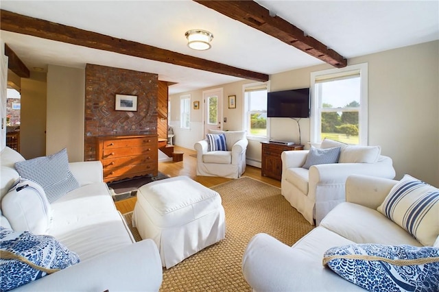 1087 Lakeside Dr, Block Island, RI 02807 - living area with light wood finished floors, beam ceiling, and a baseboard radiator