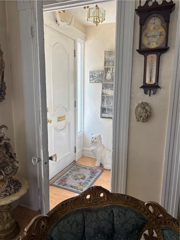 259 Park Ave, Woonsocket, RI 02895 - bathroom with wood finished floors, a chandelier, and baseboards