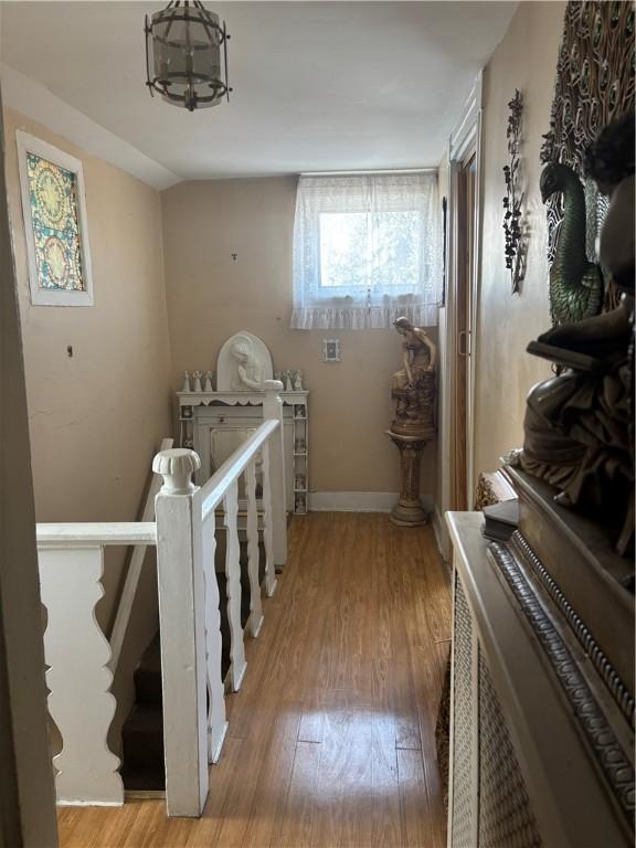 259 Park Ave, Woonsocket, RI 02895 - hallway with an upstairs landing, wood finished floors, baseboards, and a chandelier