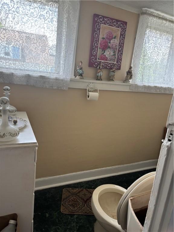259 Park Ave, Woonsocket, RI 02895 - bathroom featuring toilet and baseboards