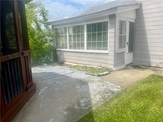 259 Park Ave, Woonsocket, RI 02895 - view of side of property featuring a shingled roof and a patio