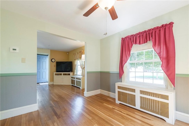 369 Vine St, Pawtucket, RI 02861 - empty room with radiator heating unit, baseboards, wood finished floors, and ceiling fan