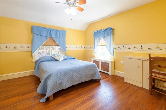 369 Vine St, Pawtucket, RI 02861 - bedroom featuring radiator, multiple windows, lofted ceiling, wood-type flooring, and baseboards