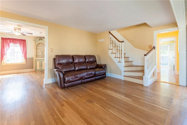 369 Vine St, Pawtucket, RI 02861 - living room with light wood finished floors, baseboards, stairs, and a ceiling fan