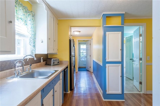 369 Vine St, Pawtucket, RI 02861 - kitchen featuring white cabinetry, a sink, dark wood-style flooring, light countertops, and freestanding refrigerator