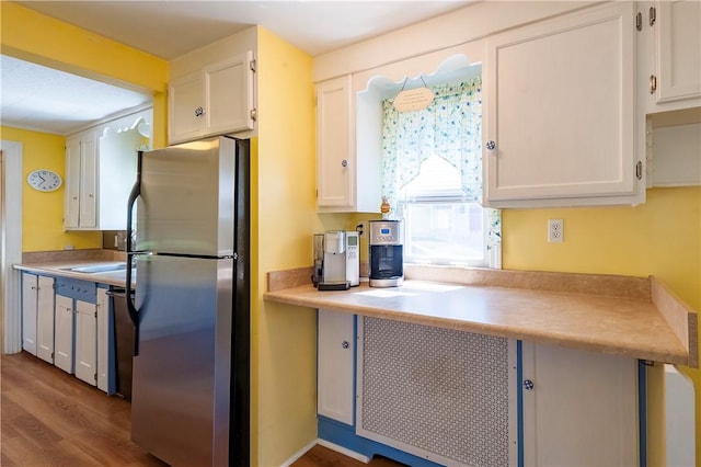 369 Vine St, Pawtucket, RI 02861 - kitchen with freestanding refrigerator, white cabinets, dark wood-style floors, and light countertops