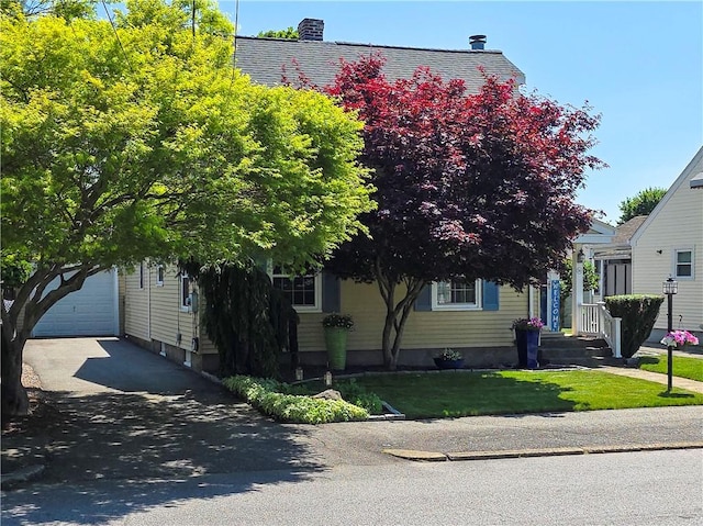 369 Vine St, Pawtucket, RI 02861 - view of property hidden behind natural elements featuring driveway, a garage, and a front lawn