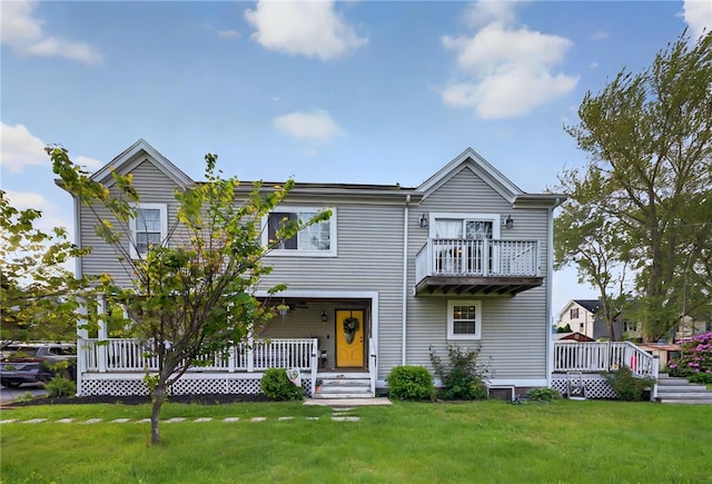 69 Arnold St, Lincoln, RI 02865 - view of front of house featuring a porch, a front lawn, and a balcony