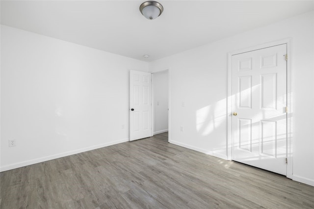 38 Brook St, Central Falls, RI 02863 - empty room with wood finished floors and baseboards