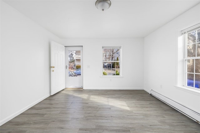 38 Brook St, Central Falls, RI 02863 - empty room with a baseboard radiator, wood finished floors, and baseboards