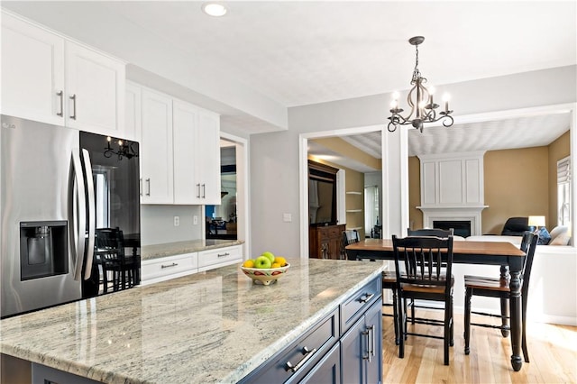 110 Fieldstone Ln, North Kingstown, RI 02874 - kitchen featuring a chandelier, stainless steel refrigerator with ice dispenser, white cabinetry, pendant lighting, and light wood-type flooring