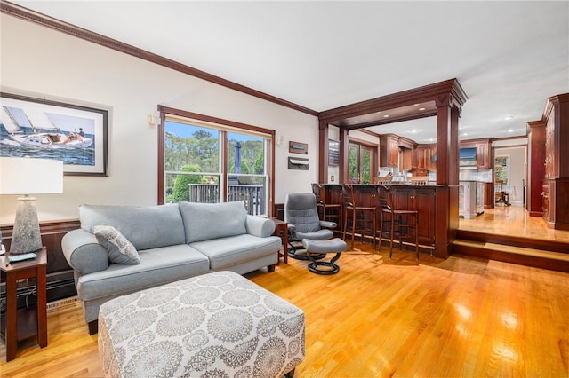 831 N Quidnessett Rd, North Kingstown, RI 02852 - living room with ornamental molding and light wood-style floors