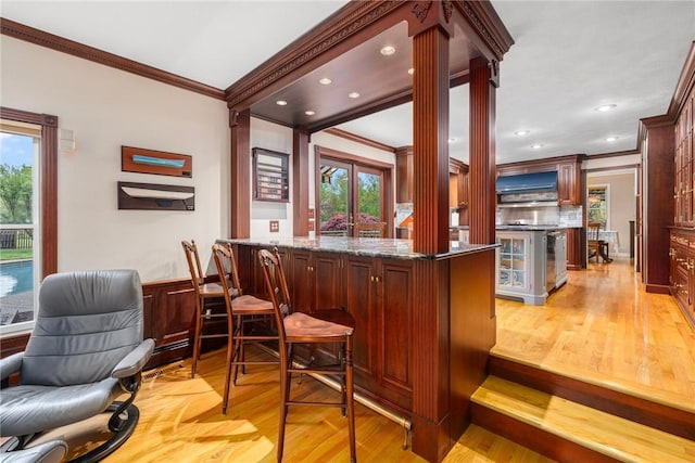 831 N Quidnessett Rd, North Kingstown, RI 02852 - indoor bar featuring ornamental molding, ornate columns, recessed lighting, and light wood finished floors