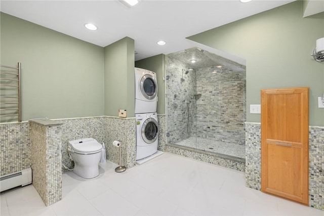 831 N Quidnessett Rd, North Kingstown, RI 02852 - full bath with stacked washer and clothes dryer, tile walls, a shower stall, toilet, and wainscoting