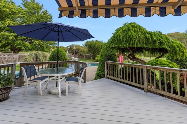 831 N Quidnessett Rd, North Kingstown, RI 02852 - wooden deck with outdoor dining space and a fenced backyard