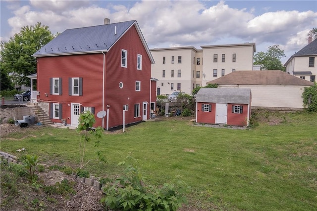 132 Chestnut St, Woonsocket, RI 02895 - back of house with a lawn and a chimney