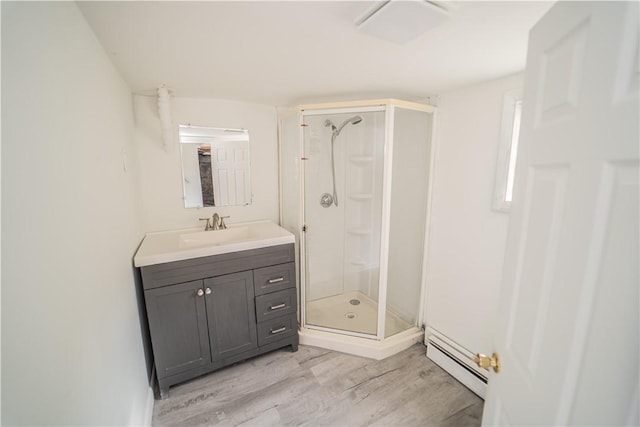 132 Chestnut St, Woonsocket, RI 02895 - full bath with baseboard heating, wood finished floors, a shower stall, and vanity