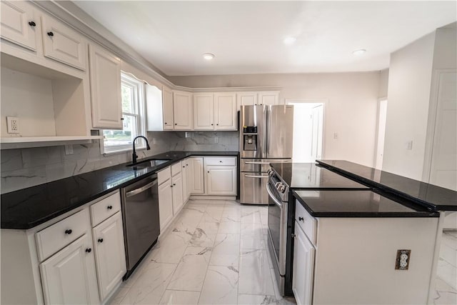 132 Chestnut St, Woonsocket, RI 02895 - kitchen featuring stainless steel appliances, a sink, light marble finish floors, a kitchen island, and recessed lighting