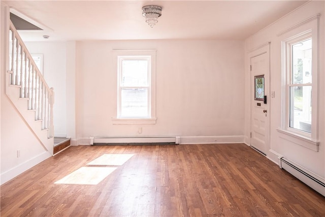 132 Chestnut St, Woonsocket, RI 02895 - entrance foyer featuring a baseboard heating unit, wood finished floors, and plenty of natural light