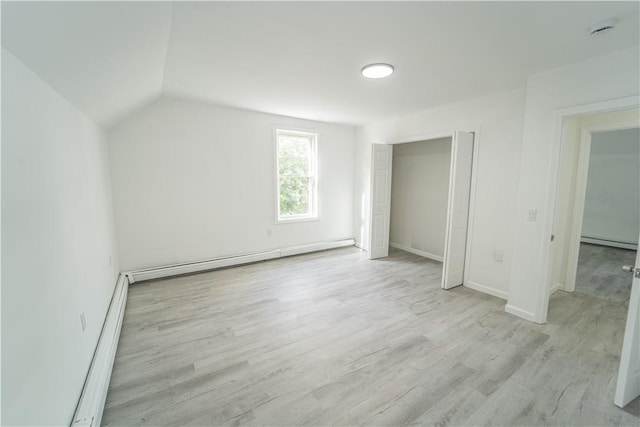 132 Chestnut St, Woonsocket, RI 02895 - additional living space featuring a baseboard heating unit, baseboard heating, light wood finished floors, baseboards, and lofted ceiling