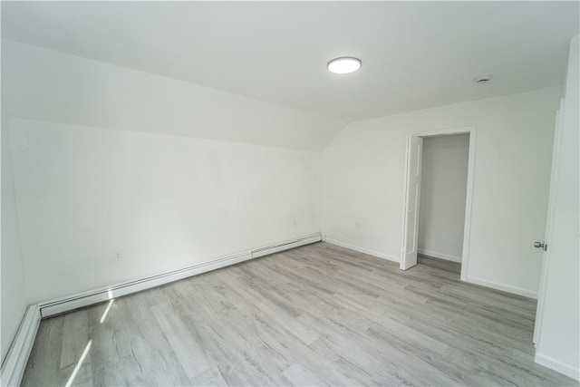 132 Chestnut St, Woonsocket, RI 02895 - additional living space with light wood finished floors, vaulted ceiling, baseboards, and baseboard heating
