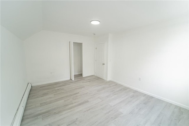 132 Chestnut St, Woonsocket, RI 02895 - spare room with a baseboard heating unit, light wood-style floors, and baseboards