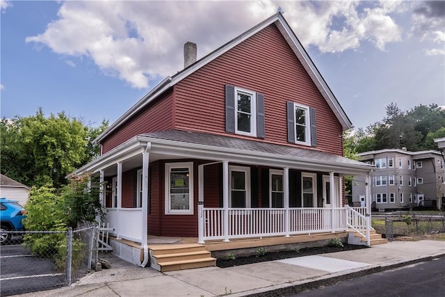 132 Chestnut St, Woonsocket, RI 02895 - farmhouse-style home with covered porch and a chimney