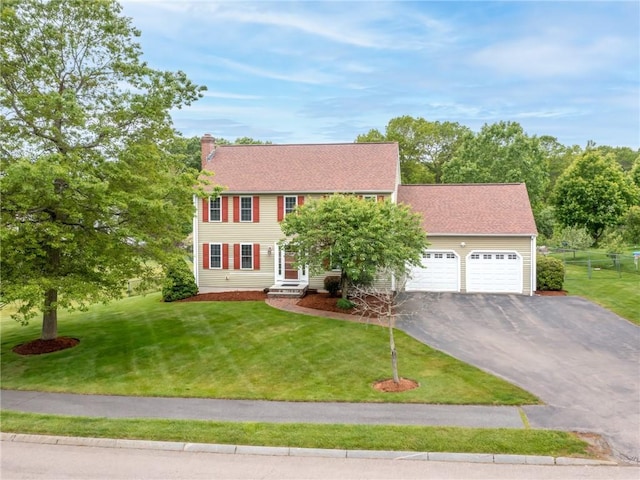 60 Broad St, Plainville, MA 02762 - colonial home with asphalt driveway, an attached garage, and a chimney
