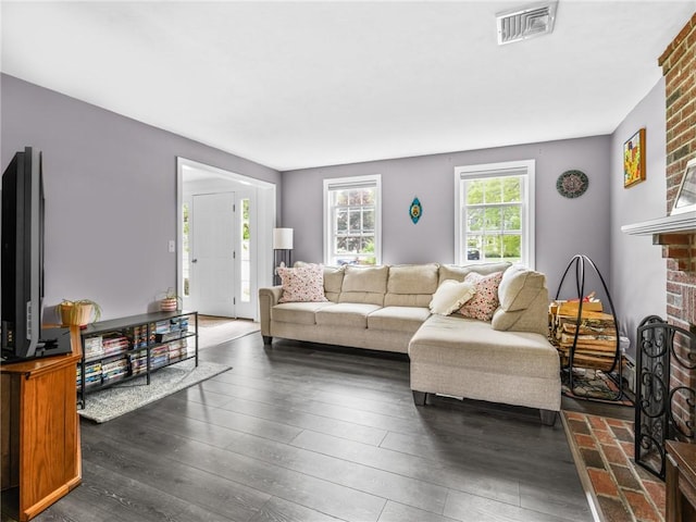 60 Broad St, Plainville, MA 02762 - living area with a fireplace and dark wood-type flooring
