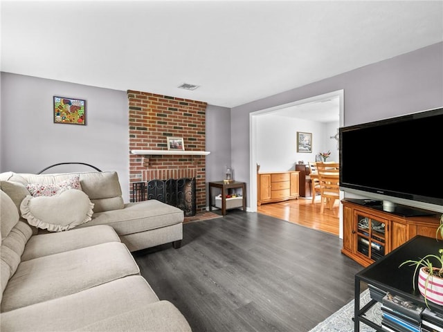 60 Broad St, Plainville, MA 02762 - living area with wood finished floors and a fireplace