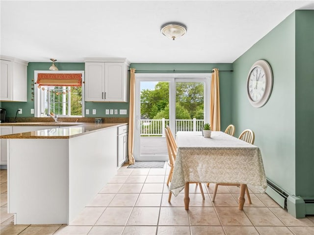 60 Broad St, Plainville, MA 02762 - kitchen with white cabinetry, a peninsula, light tile patterned floors, and a sink