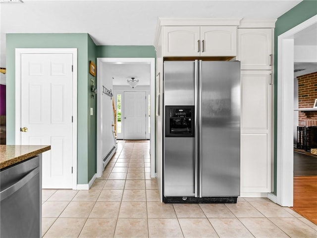60 Broad St, Plainville, MA 02762 - kitchen featuring stainless steel appliances, light tile patterned flooring, white cabinets, and dark stone counters