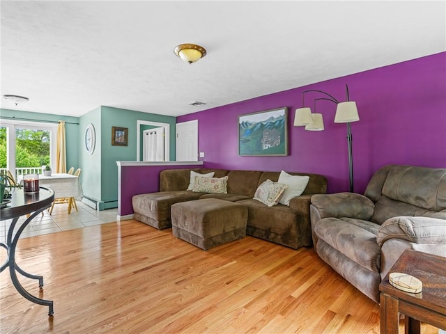 60 Broad St, Plainville, MA 02762 - living area featuring wood finished floors and a baseboard heating unit