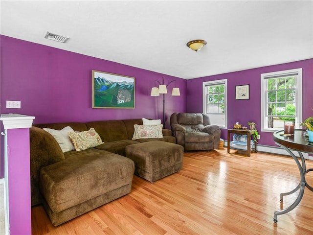 60 Broad St, Plainville, MA 02762 - living room with light wood-style floors and a baseboard radiator