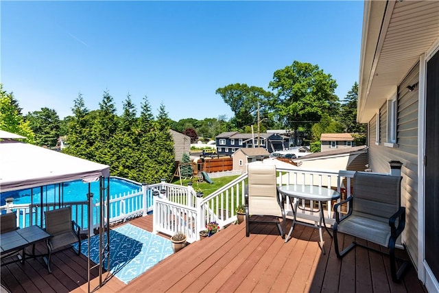 7 Lydia Ave, North Providence, RI 02904 - wooden deck featuring a playground and view of wooded area
