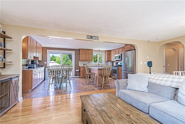 7 Lydia Ave, North Providence, RI 02904 - living area with arched walkways, light wood-type flooring, and recessed lighting