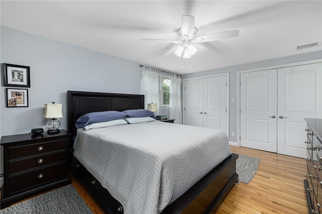 48 Nottingham Dr, Scituate, RI 02831 - bedroom featuring two closets, wood finished floors, and ceiling fan