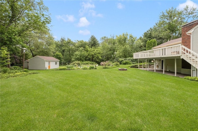 48 Nottingham Dr, Scituate, RI 02831 - view of grassy yard featuring a deck and an outdoor fire pit