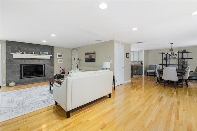 48 Nottingham Dr, Scituate, RI 02831 - living room with light wood-type flooring, a fireplace, recessed lighting, a chandelier, and baseboards