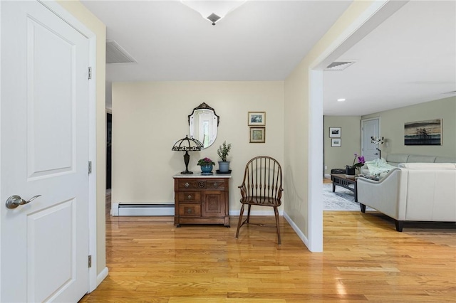 48 Nottingham Dr, Scituate, RI 02831 - hallway with light wood finished floors, a baseboard heating unit, and baseboards
