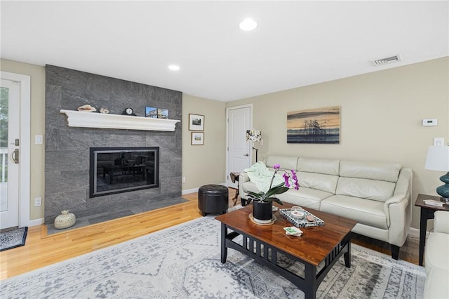48 Nottingham Dr, Scituate, RI 02831 - living room with wood finished floors, baseboards, a tile fireplace, and recessed lighting